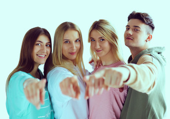 Young people pointing at you standing together