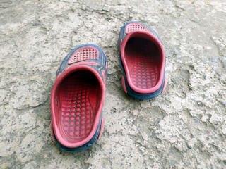 a dirty children footwear  put on a ground