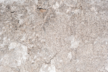 Texture of the old wall of an old gray house. Texture with cracks in the wall.