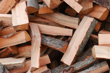 firewood for the fire, background. Dry chopped firewood logs ready for winter