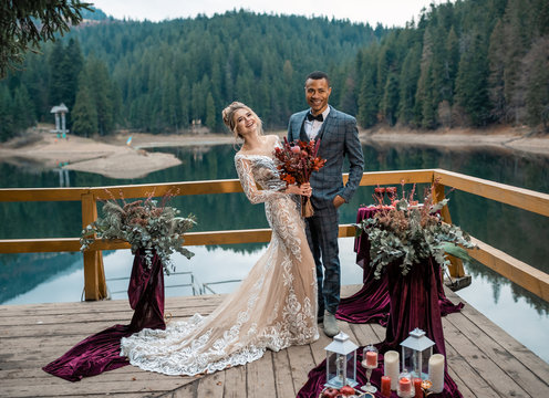 Lovely wedding couple, african groom and Caucasian bride, waiting the wedding ceremony. Wedding rest, relax honeymoon concept