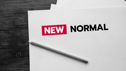 New Normal text - blank paper on wooden background. Coronavirus pandemic concept.