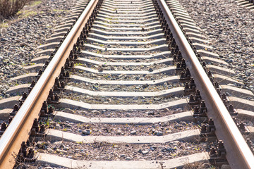 Old slightly rusty railroad tracks on which trains still ride.