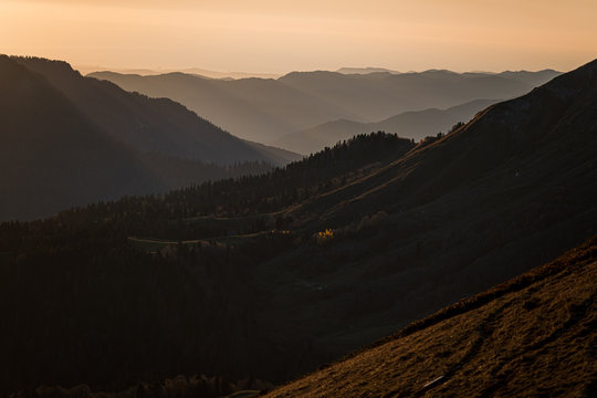 Sochi, Rosa khutor landscape. Colorful sunset in the mountains. Tenuous evening mist covering the forestland and the mountains.