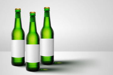 Green beer bottles with blank label mock-up advertising