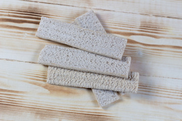 Crisp bread slices on wooden background