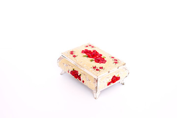 A closed beige jewelry box stands sideways against a white background. isolated object.