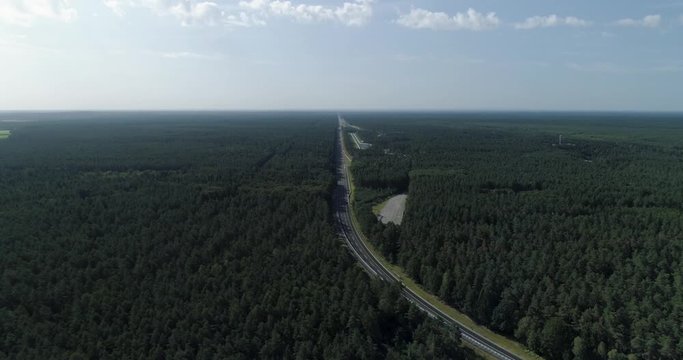 Very long straight road for vehicle testing that goes off into distance with huge forest, Germany