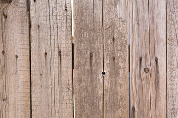 The texture of the boards. Brown painted fence.