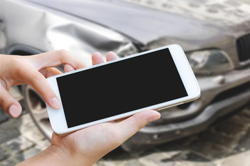 woman hand hold and touch screen smart phone or cellphone over blurred of car accident background.