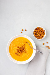 Homemade Butternut Squash Soup in White Bowl on Gray background; Roasted Chickpea Garnish