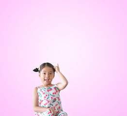 Asian child wow or kid girl thinking with finger point up on top for new idea to imagination education with smiling happy at nursery pre school on pink space background isolated with clipping path