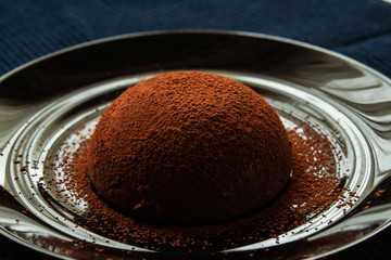Chocolate сream pudding on a black plate