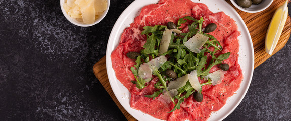 Marbled beef carpaccio with arugula, capers and parmesan cheese