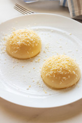 Cream pudding with vanilla on a white plate.