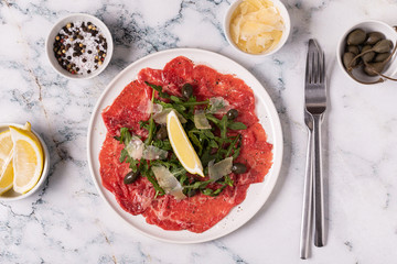 Marbled beef carpaccio with arugula, capers, lemon and parmesan cheese