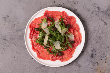 Marbled beef carpaccio with arugula, capers and parmesan cheese