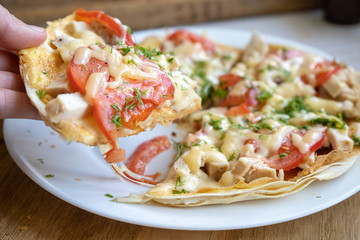 quick pizza on a pita bread with chicken, tomatoes and cheese