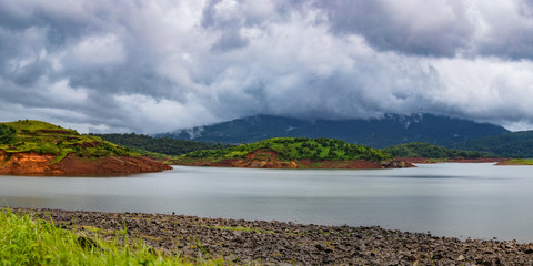 Naklejka premium beautiful landscape lake and hills panorama, Banasura, Kerala, India