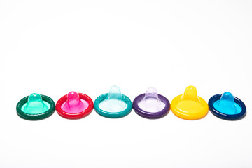 Multi-colored condom on a white background. Contraception. Safe sex