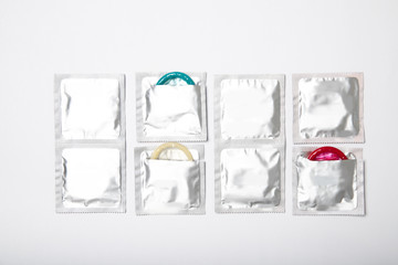 Condoms on a white background. Colored condoms. Contraception