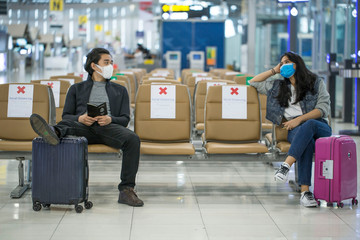 Backpacker travelers Asian women wearing masks covid 19 disease Prevention An sitting, creating a...