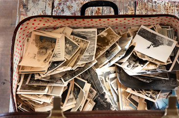 Lots of vintage photos in an old suitcase. Old photos