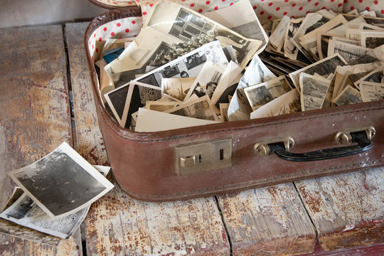 Lots of vintage photos in an old suitcase. Old photos