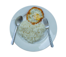 fried crispy egg on parboiled rice in a separate white plate on a white background. Heart shaped rice and fried egg on a white plate. famous Thai fried food.