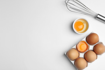 Flat lay composition with chicken eggs on white background. Space for text