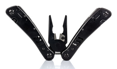 Open pliers of black multi tool knife isolated on white background with reflection on glossy surface. Multipurpose knife close-up image