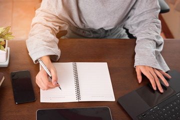 Close up hand writing note for work at home. Freelancer hand planing and taking note schedule. Work at home concept.