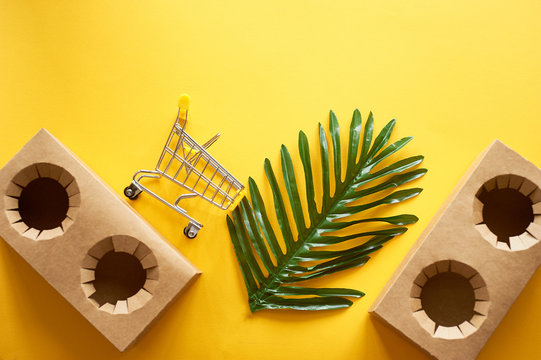 Food delivery, cardboard cup holders. Online shopping for ready meals. Yellow background, shopping trolley.