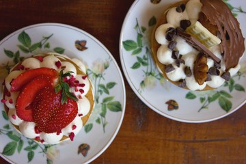 Two tasty cakes on wooden table