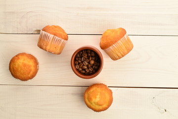 Tasty sweet muffins, close-up, on a painted wooden table.