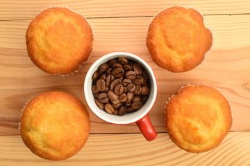 Tasty sweet muffins, close-up, on a wooden table.
