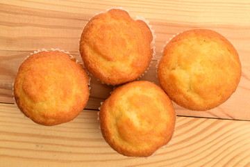 Tasty sweet muffins, close-up, on a wooden table.