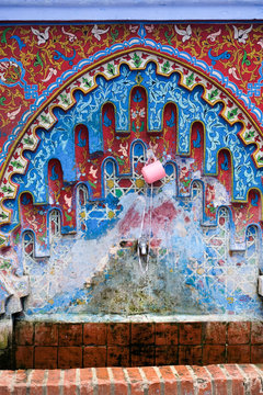 Decorated fountain with mosaic tiles in Chefchaouen, Morocco.