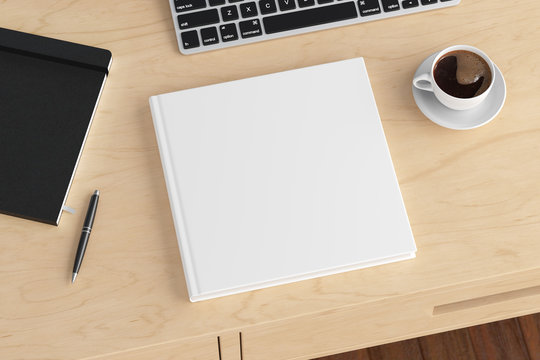 Square book cover mock up. Workspace on wooden desk with cup of coffee. Side view. 3d render