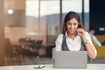 Modern business woman in the office working at computer