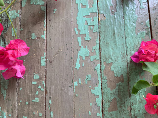 Leaves and Flowers on Wooden Background