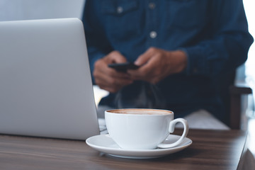 Casual business man working on laptop computer on table in coffee shop co working space