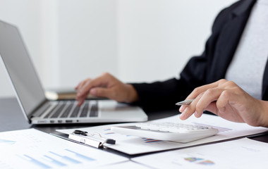 Accounting businessmen are calculating income-expenditure and analyzing real estate investment data, Financial and tax systems concept.