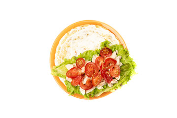Tomato slices on chicken fillet over lettuce.