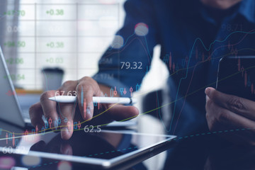 Business man analyzing stock market report with financial graph interface for business analysis...