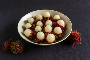 Rambutan, a delicious Thai fruit served on a plate