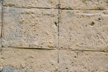 Texture of old tattered wall or gray yellow concrete fence