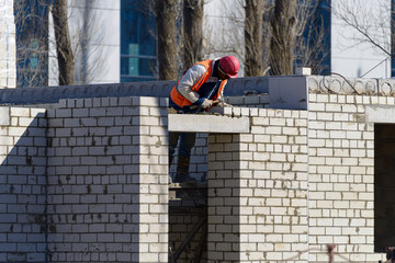 Construction of a new house. Workers erect the second floor of a building on a construction site.