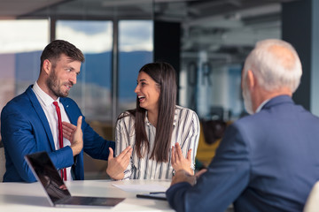 Positive aged couple consulting with insurance agent