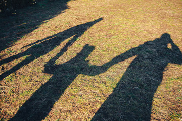 Family-mom, dad and me. Walking along a country road in hot summer.